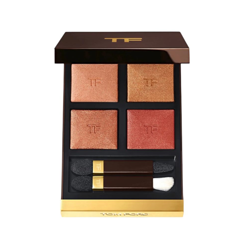 Makeup palette with four shades and applicators on a white background