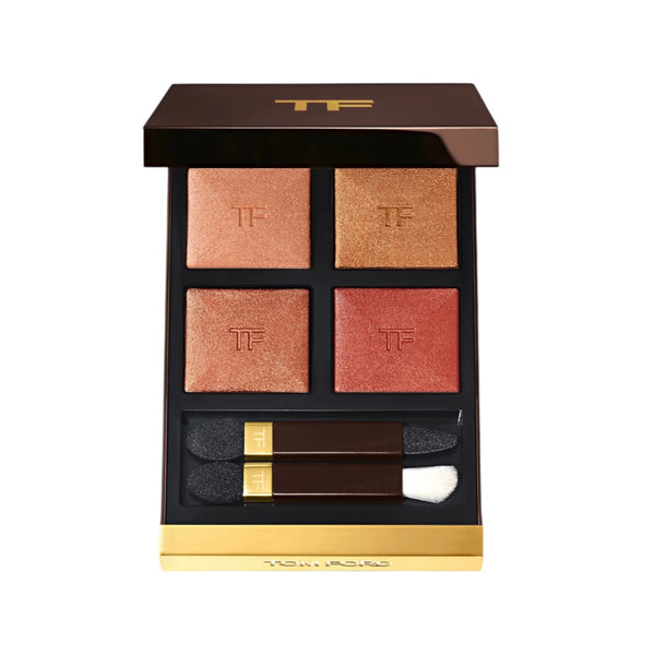 Makeup palette with four shades and applicators on a white background