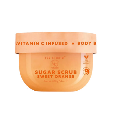 A jar of Yes Studio Sugar Scrub with 'VITAMIN C INFUSED' and 'SWEET ORANGE' labels, indicating the key ingredients.